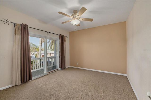 carpeted spare room featuring ceiling fan