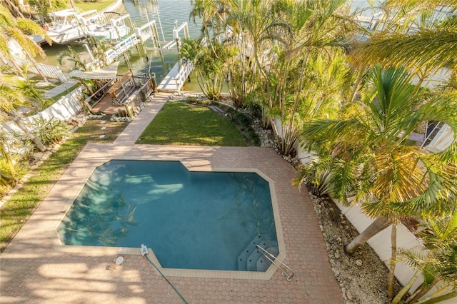 view of pool featuring a patio area and a water view