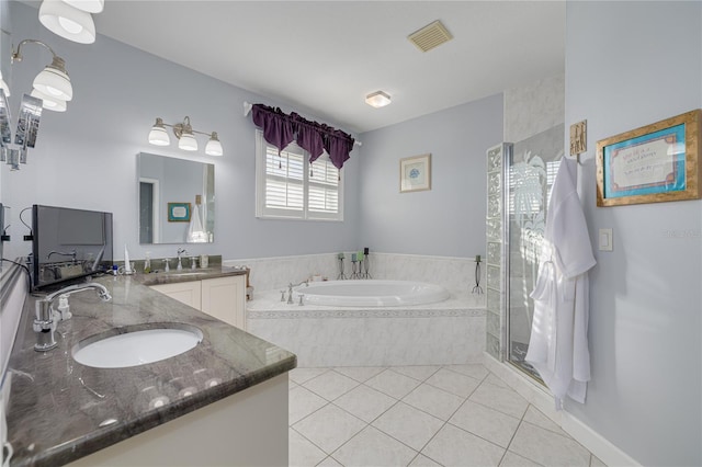 bathroom with tile patterned flooring, vanity, and separate shower and tub