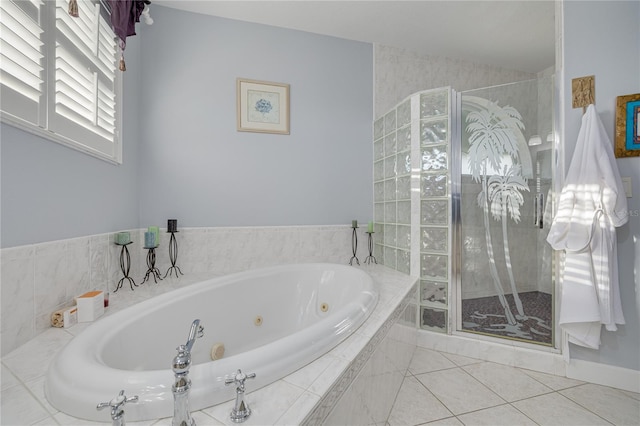 bathroom with tiled bath and tile patterned floors