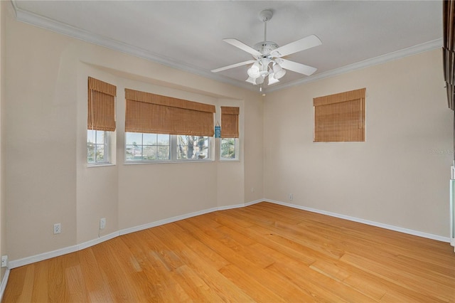 spare room with crown molding, ceiling fan, and light wood-type flooring