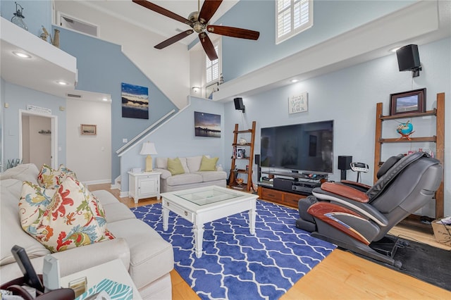 238 71st Ave, St Pete Beach, FL 33706 - living area featuring a towering ceiling, a ceiling fan, and wood finished floors