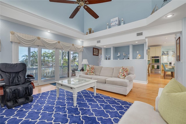 238 71st Ave, St Pete Beach, FL 33706 - living room featuring wood finished floors, ceiling fan, a high ceiling, and visible vents