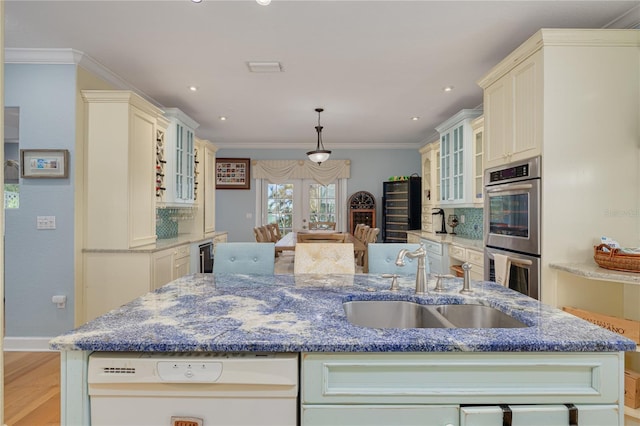 238 71st Ave, St Pete Beach, FL 33706 - kitchen featuring dishwasher, a sink, an island with sink, french doors, and stainless steel double oven