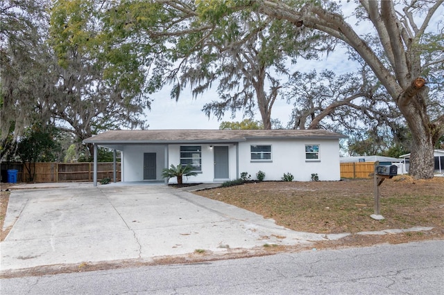 ranch-style home featuring a carport