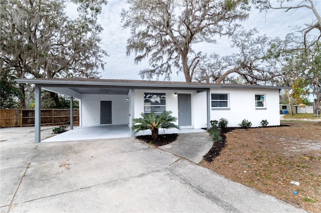 ranch-style home featuring a carport