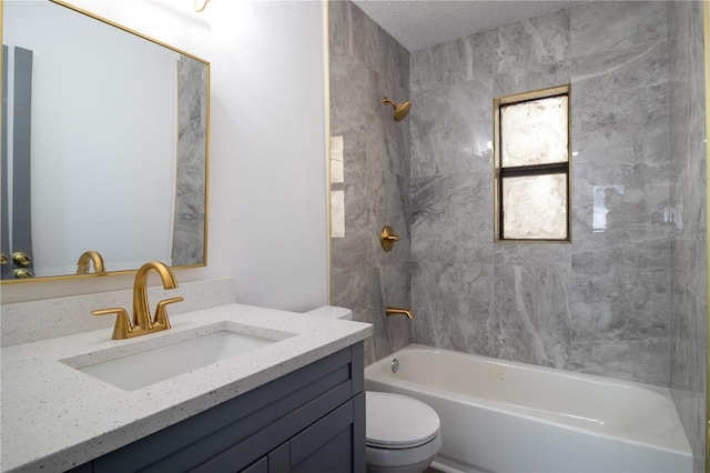 full bathroom with tiled shower / bath combo, toilet, and vanity