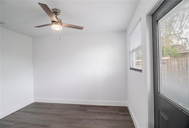 spare room with dark wood-type flooring and ceiling fan