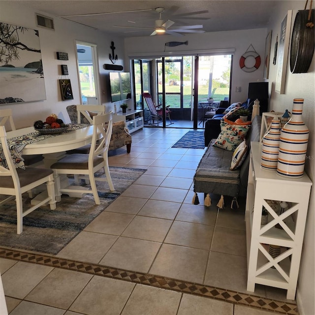 tiled living room featuring ceiling fan