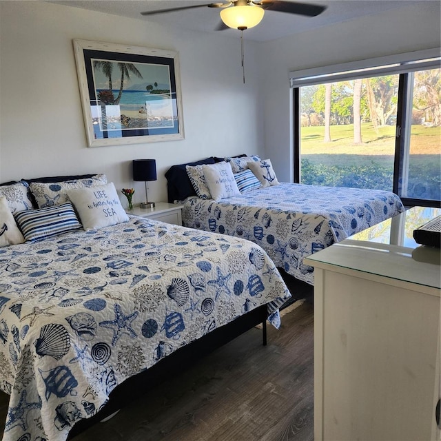 bedroom with ceiling fan and dark wood-type flooring