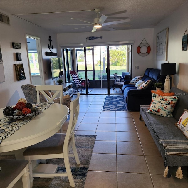 tiled living room with ceiling fan