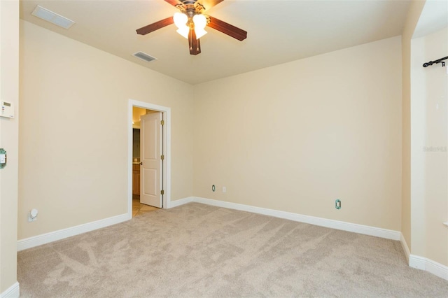 carpeted spare room with ceiling fan