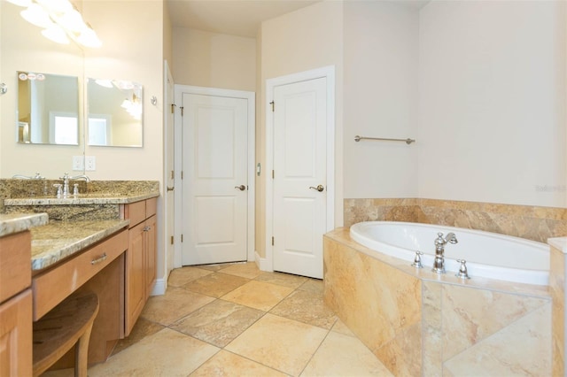 bathroom featuring vanity and tiled tub