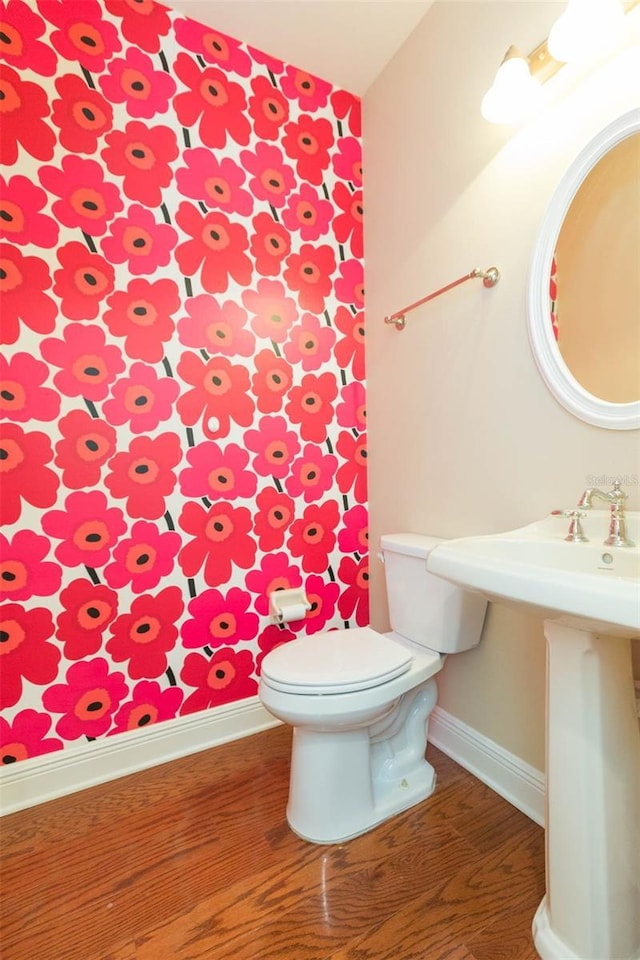 bathroom featuring hardwood / wood-style flooring and toilet