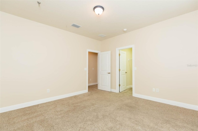 unfurnished room with light carpet