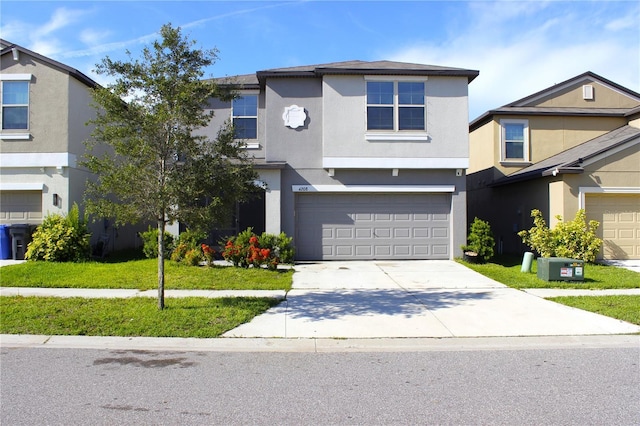 front of property featuring a front yard and a garage