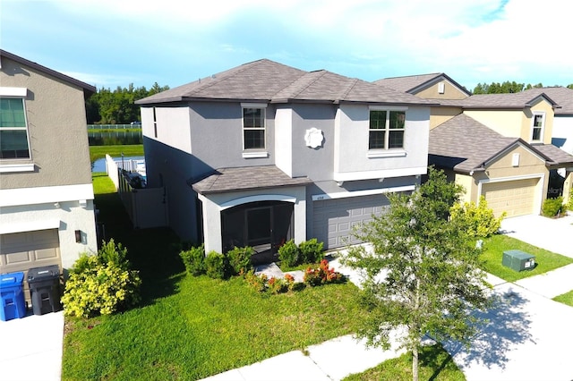 view of front of home with a front yard and a garage