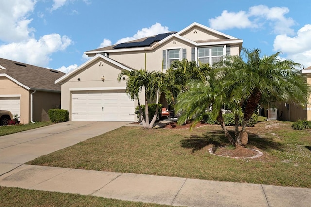 view of front of home with solar panels, a garage, and a front lawn