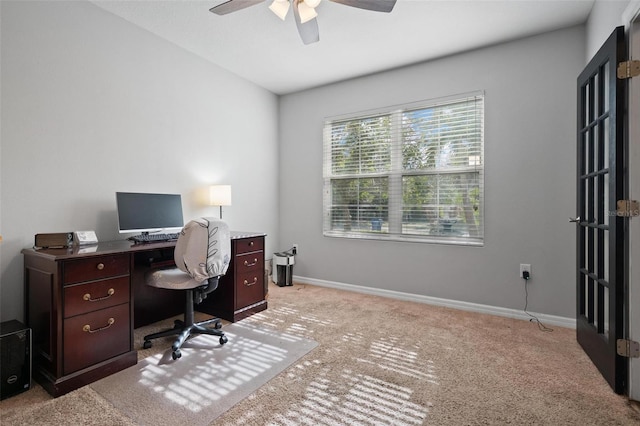 home office featuring light colored carpet and ceiling fan