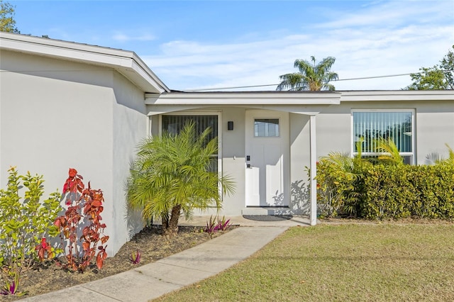 property entrance with a yard