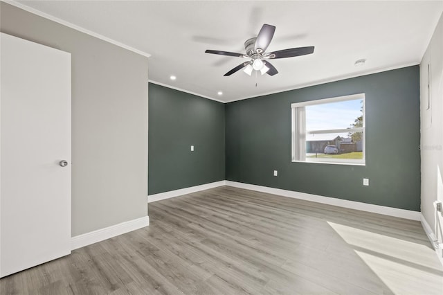 empty room featuring ceiling fan, light hardwood / wood-style floors, and ornamental molding