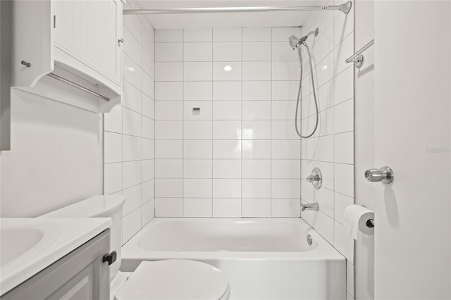 full bathroom with toilet, vanity, and tiled shower / bath combo