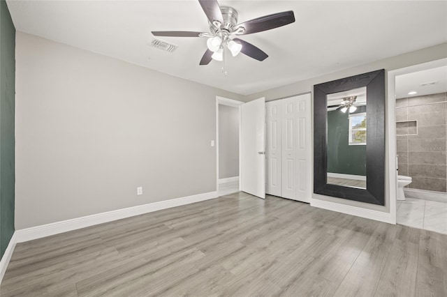 unfurnished bedroom with ensuite bath, ceiling fan, a closet, and light hardwood / wood-style flooring