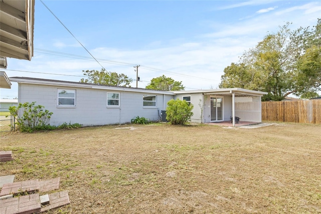 rear view of property with a yard and a patio