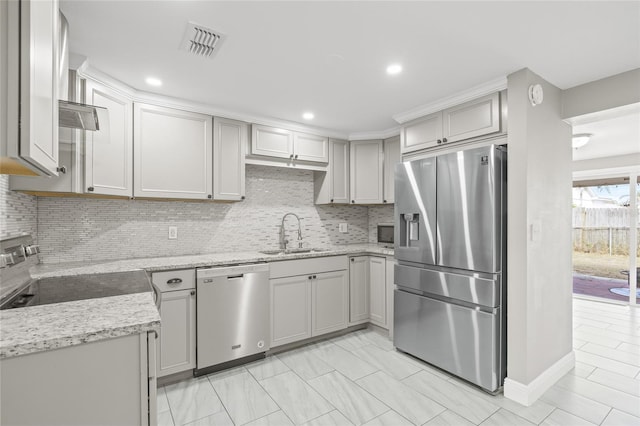 kitchen with gray cabinetry, light stone countertops, sink, tasteful backsplash, and appliances with stainless steel finishes