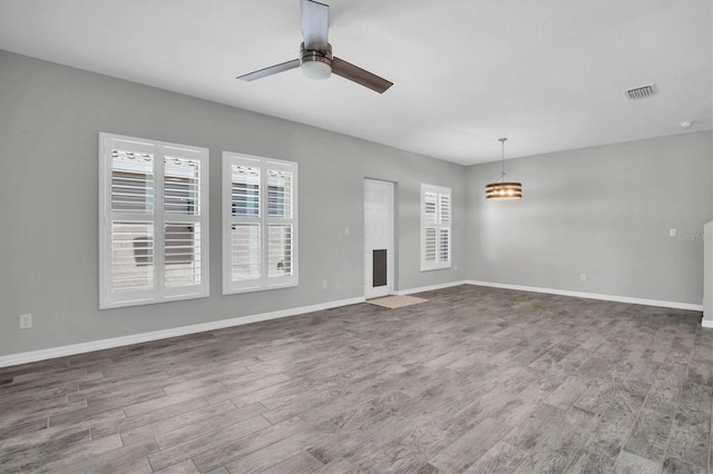 spare room with ceiling fan and hardwood / wood-style flooring