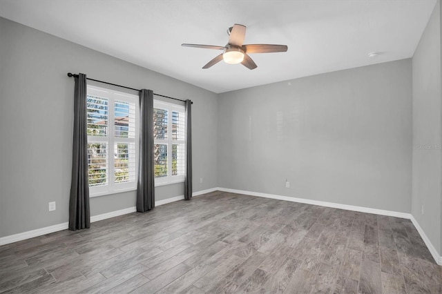 unfurnished room with ceiling fan and hardwood / wood-style floors