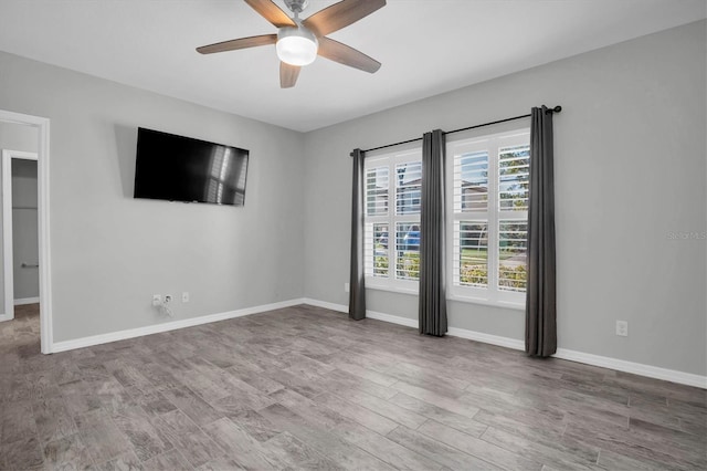 unfurnished room featuring ceiling fan and hardwood / wood-style floors