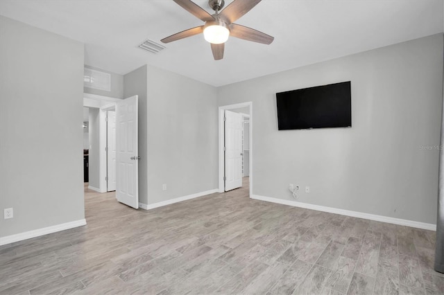 spare room featuring ceiling fan and light hardwood / wood-style floors