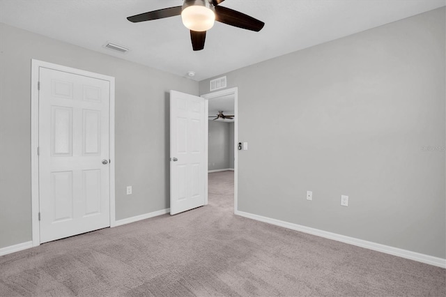 unfurnished bedroom with ceiling fan and light carpet