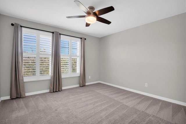 spare room with light carpet and ceiling fan