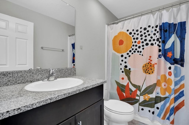 bathroom with vanity, toilet, and curtained shower