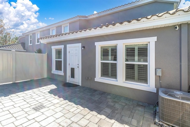 rear view of house featuring a patio and central air condition unit