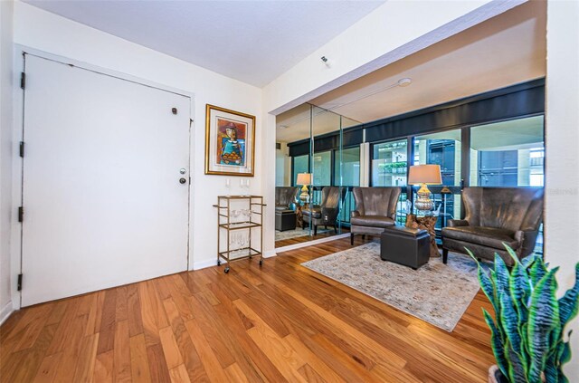 sitting room featuring wood-type flooring and floor to ceiling windows