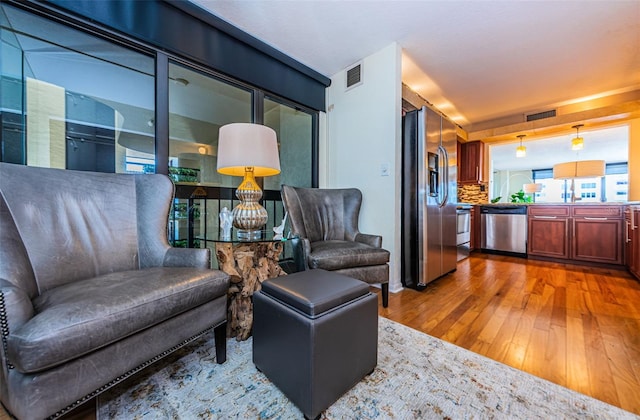 sitting room with hardwood / wood-style floors