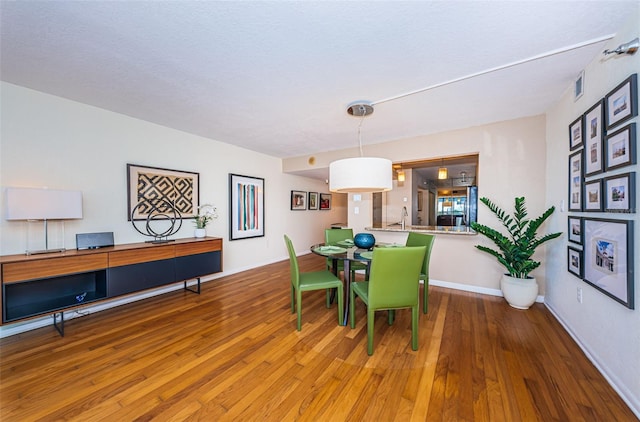 dining space with hardwood / wood-style flooring