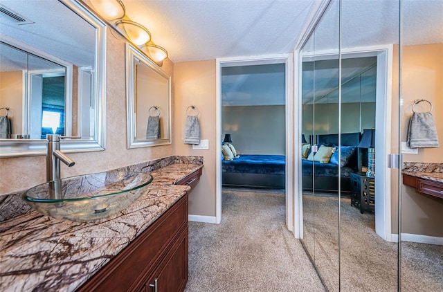 bathroom featuring vanity and a textured ceiling