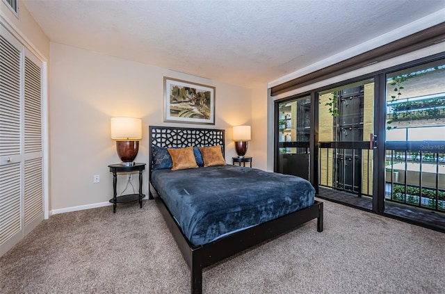 carpeted bedroom with access to outside, a textured ceiling, and a closet