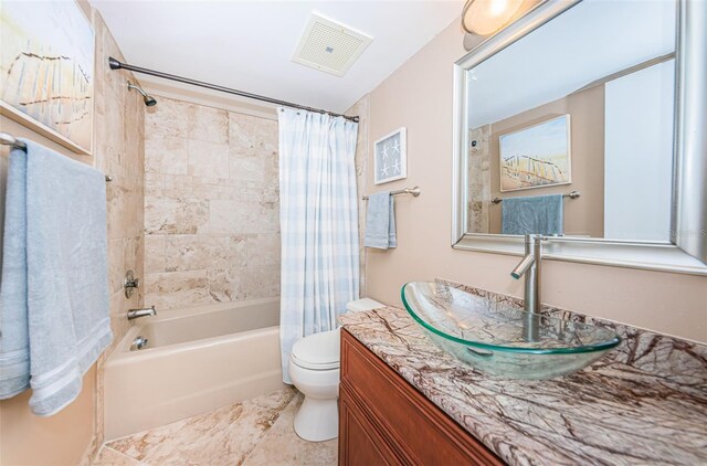 full bathroom with shower / bath combination with curtain, vanity, and toilet