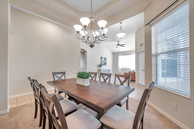 dining room with ceiling fan with notable chandelier and light tile patterned floors