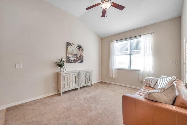 sitting room with light carpet, vaulted ceiling, and ceiling fan