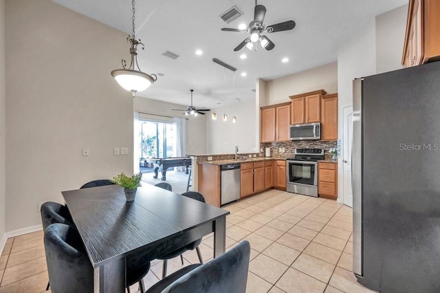 kitchen with sink, backsplash, stainless steel appliances, and light tile patterned flooring