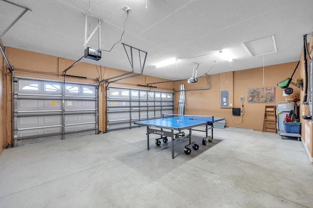 garage with electric panel and a garage door opener