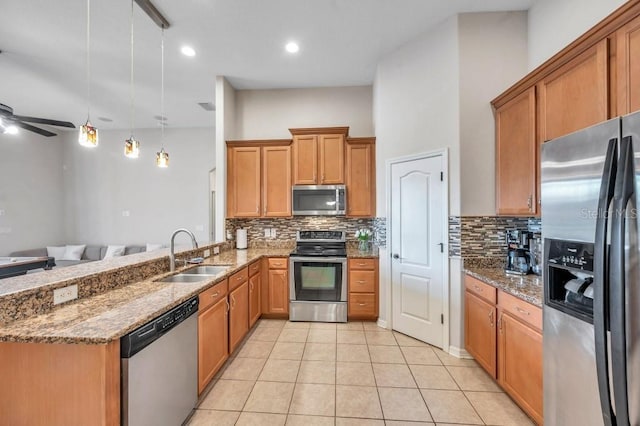 kitchen with sink, ceiling fan, appliances with stainless steel finishes, decorative light fixtures, and light tile patterned flooring