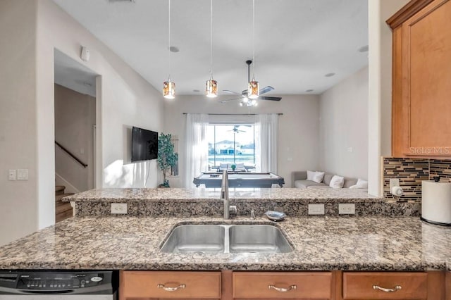 kitchen featuring ceiling fan, sink, dishwasher, and light stone counters