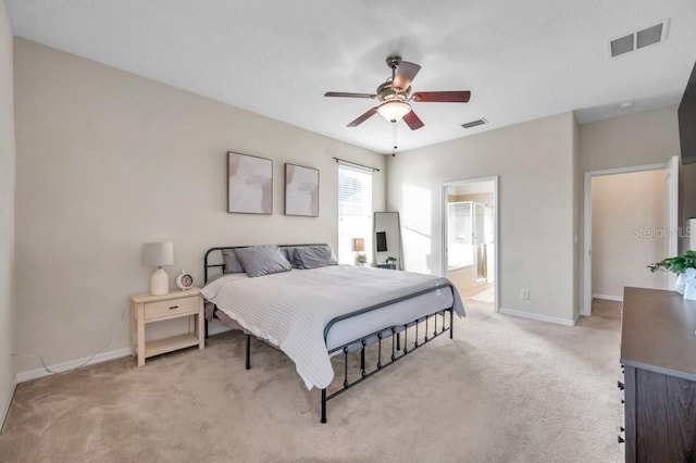 carpeted bedroom featuring ensuite bath and ceiling fan